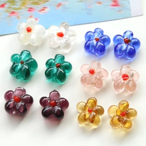 Flat lay of colorful glass flower beads for DIY jewelry making in various vibrant colors