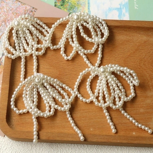 Set of four cream white faux pearl bow accessories for DIY jewelry and hair decor