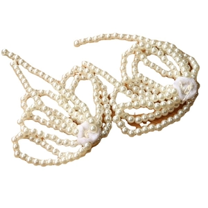 Elegant white faux pearl body chain bra top with tassel details on a woven background
