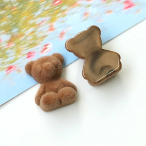 Detailed view of flocked teddy bear DIY charms with plush front and flat resin back