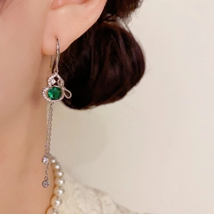 Elegant long tassel earrings featuring emerald green gemstone and silver dangles for women