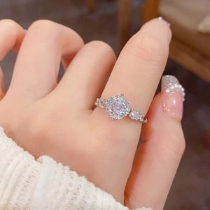 Close-up of elegant silver ring featuring a large round-cut zircon on the finger
