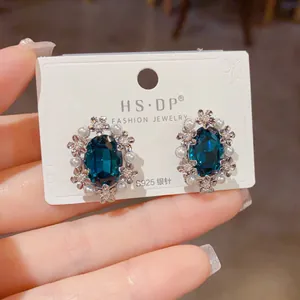 Detail of S925 silver needle vintage floral earring with oval blue stone and white pearls