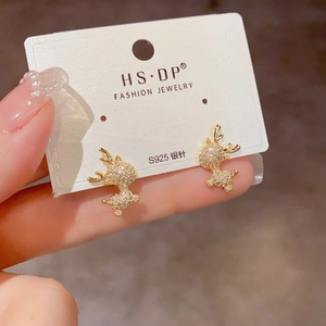 Close-up of sparkling reindeer stud earrings with gold finish and inlaid zircons