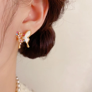 Detail showing the butterfly stud earring with colorful zircon pavé and pearl center