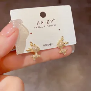 Detail of S925 silver needle on gold reindeer stud earrings with sparkling pavé zircons