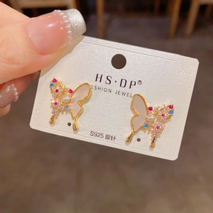 Detailed macro of S925 silver needle butterfly earrings with colorful stones and pearl