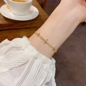 Elegant gold north star bracelet with sparkling zircon stones on a female wrist