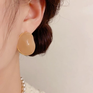 French style irregular round cream enamel earrings with gold trim on model