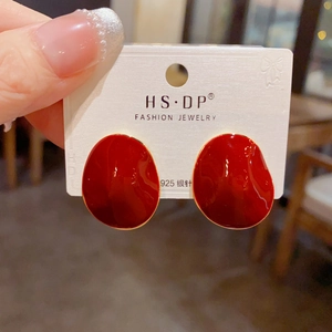 Detail of red enamel irregular geometric earrings with gold edging and 925 silver posts