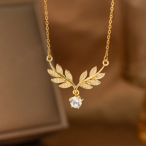Golden laurel leaf pendant necklace with shimmering zircon stones and clear round crystal