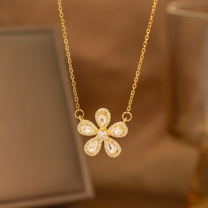 Detailed view of a gold floral pendant necklace set with five teardrop-shaped zircons