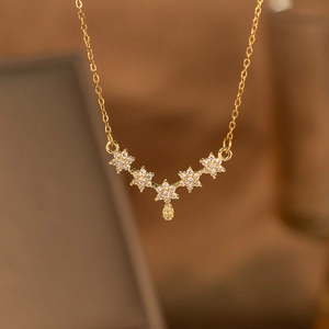 Detailed macro shot of golden laurel wreath necklace pendant with sparkling crystals