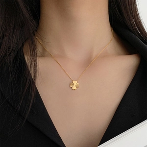 18K gold four-leaf clover necklace with heart-shaped petals and sunburst texture