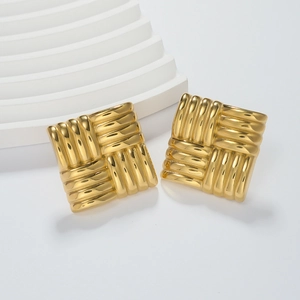 Detailed view of square gold earrings featuring a three-dimensional woven texture