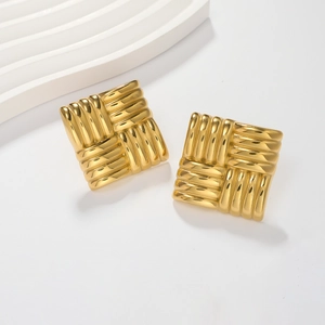 Macro shot of gold square stud earrings featuring a textured woven rib design and polished finish