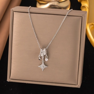Silver star pendant necklace with white pearl and zircons on a jewelry box