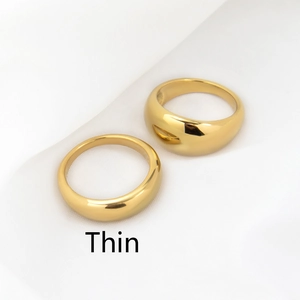 Macro shot of minimalist 18k gold plated thin ring showing polished mirror surface