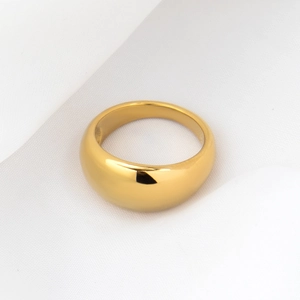 Detailed close-up of thick 18k gold plated dome ring on white silk fabric background