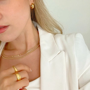 Polished 18k gold plated stainless steel jewelry set with rings, necklaces, and hoop earrings