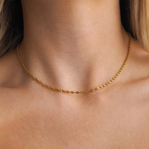 Close-up of elegant 18K gold plated stainless steel twist rope chain on female neck