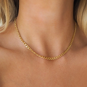Detailed close-up of 18K gold plated stainless steel Cuban curb chain necklace on a model