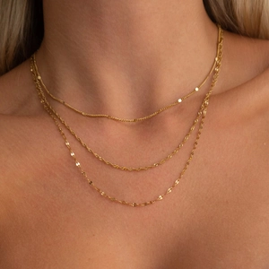 Close-up of triple-layered 18K gold plated stainless steel chains showing diverse textures