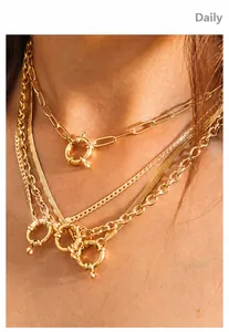 Detail of 18K gold-plated layered necklace featuring chunky spring clasp and multi-style chains