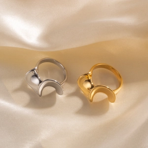Minimalist S-shaped 18k gold plated stainless steel ring set on elegant silk fabric