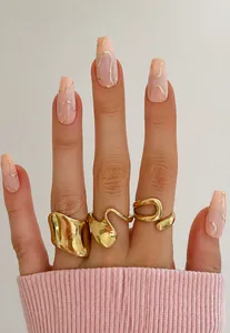 Close-up of three 18K gold plated stainless steel rings with irregular organic shapes