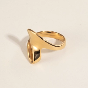Macro detail of irregular 18K gold plated stainless steel ring with polished surface