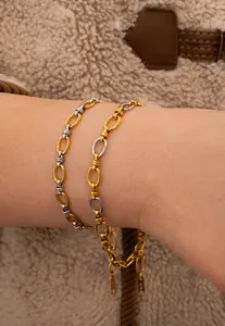 Detailed macro of two-tone gold and silver link bracelet with K18 engraved tag