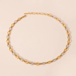 Macro shot of gold and silver S925 sterling silver chain links with lobster clasp detail