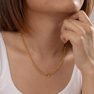 Macro shot of 18K gold plated rolo chain necklace with central ring detail on model