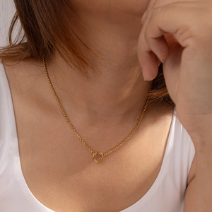 Close-up of minimalist 18K gold plated stainless steel necklace on female neck