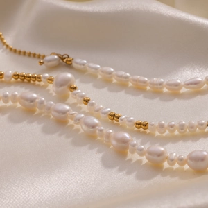 18K gold plated stainless steel bracelet with natural freshwater pearls on white silk