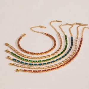 Detail of thin gold chains with multi-colored rectangular zircon stones and lobster clasp