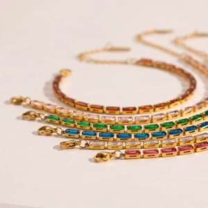 Elegant gold bracelet set with multi-colored rectangular cubic zirconia in a fan-shaped layout