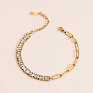 Detail of gold bracelet with rectangular clear zircons and paperclip chain links