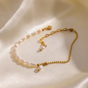 Elegant 18K gold plated stainless steel bracelet with white freshwater pearls on silk