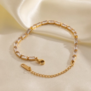 Detailed macro view of 18K gold plated bracelet with clear baguette-cut zircon stones