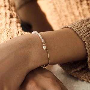 18K gold plated stainless steel bracelet with freshwater pearls on a female wrist