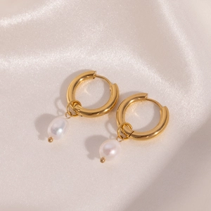 Detail of 18K gold plated hoop earrings featuring irregular white baroque pearl pendants