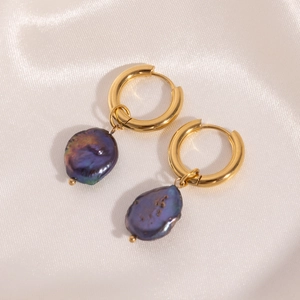 Macro view of 18K gold plated hoop earrings with iridescent purple baroque pearls