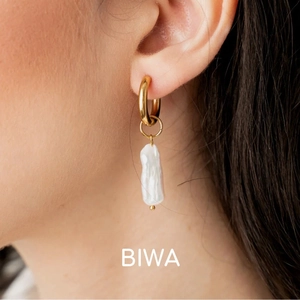 Close-up of model wearing elegant 18K gold plated earrings with white Biwa baroque pearls