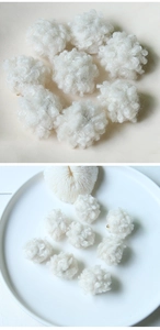 Close-up of soft white plush pom pom beads showing curly fiber texture for DIY jewelry