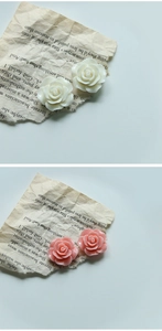 Detailed macro of 24mm resin rose flower charms in white and pink for DIY jewelry