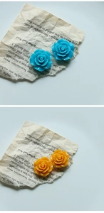 Detail of 24mm 3D resin rose flower charms in sky blue and orange for DIY jewelry crafts