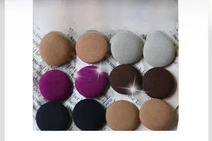 Macro detail of various fabric-covered round buttons for coats in multiple colors