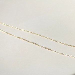 Macro detail of polished gold-plated O-chain link texture for necklace components